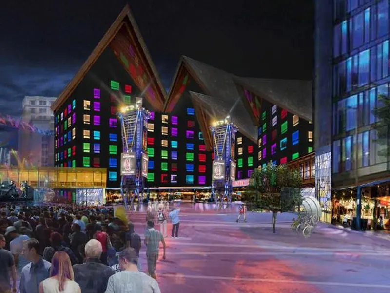 Night photomontage of a crowded square in front of buildings with colorful lit windows in Downtown East Minneapolis